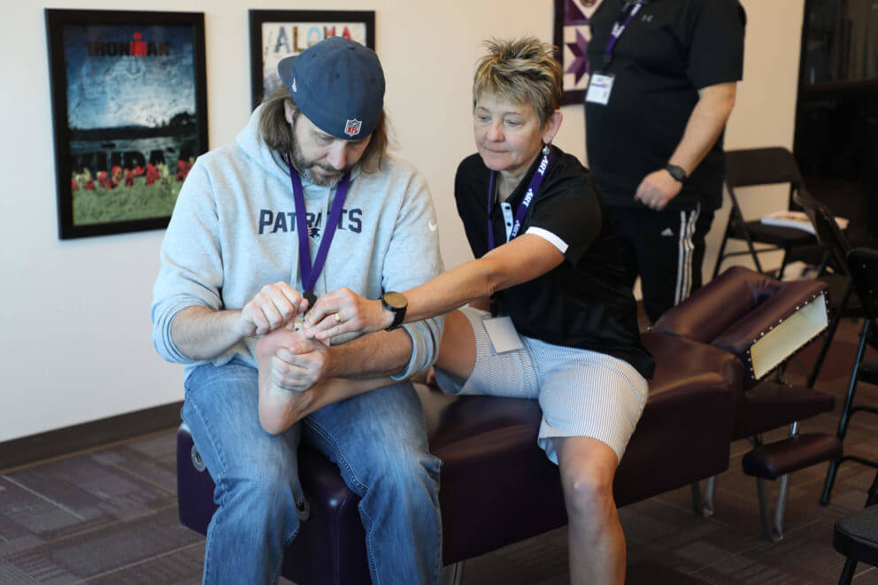 One-on-one instruction with student at lower extremity seminar